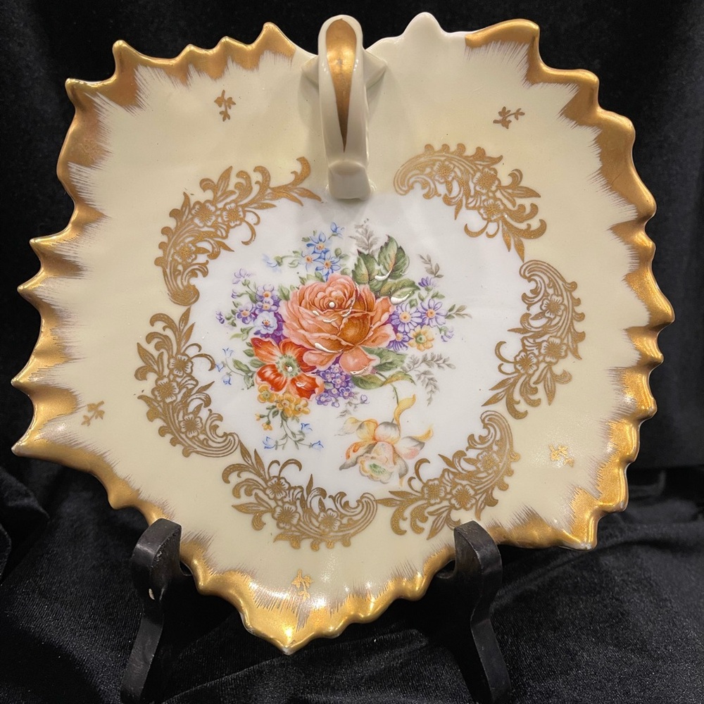 7 inch leaf shaped hand painted porcelain dish with handle.